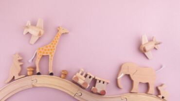 Zero waste. Eco wooden toys on pink background. Flat lay